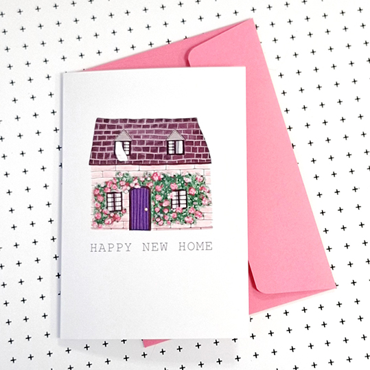 wenskaart met een illustratie van een roze huisje met de tekst happy new home